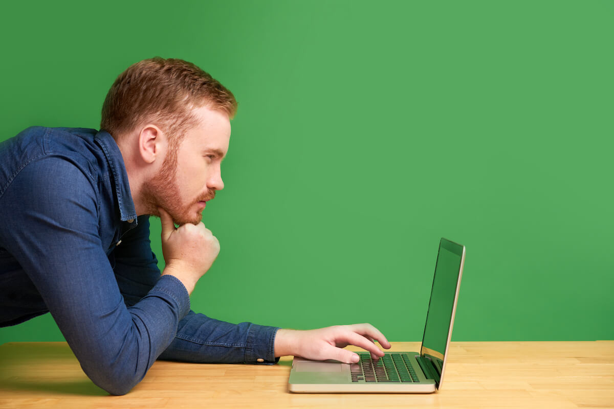 Computer glasses for men: man having a hard time reading from a laptop