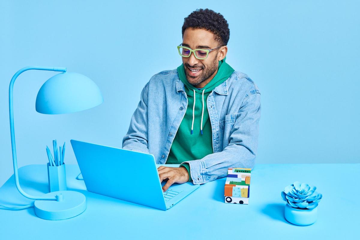 Man using a pair of blue light gaming eyeglasses
