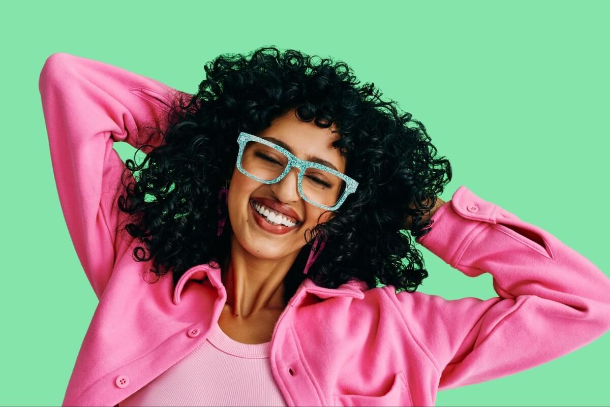 Fashion glasses: curly-haired woman wearing a pair of eyeglasses