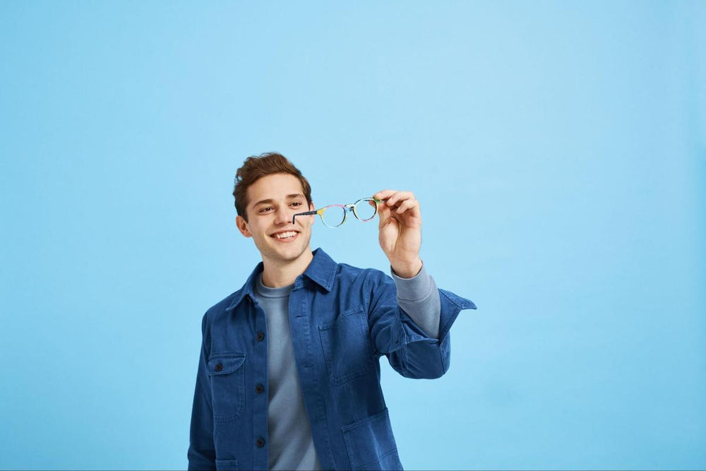 Lightweight glasses frames: man happily checking his eyeglasses