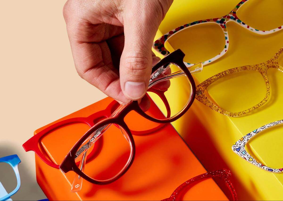 Affordable optical: person holding a pair of eyeglasses