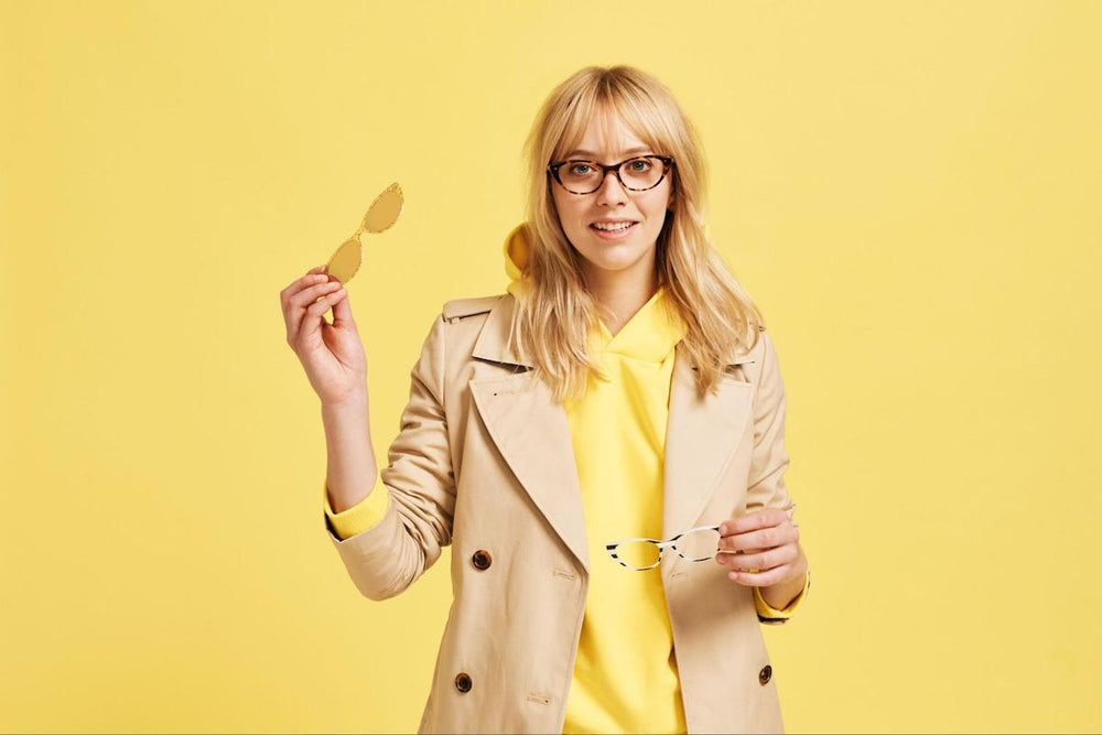 Glasses with bangs: woman holding 2 pairs of eyeglasses