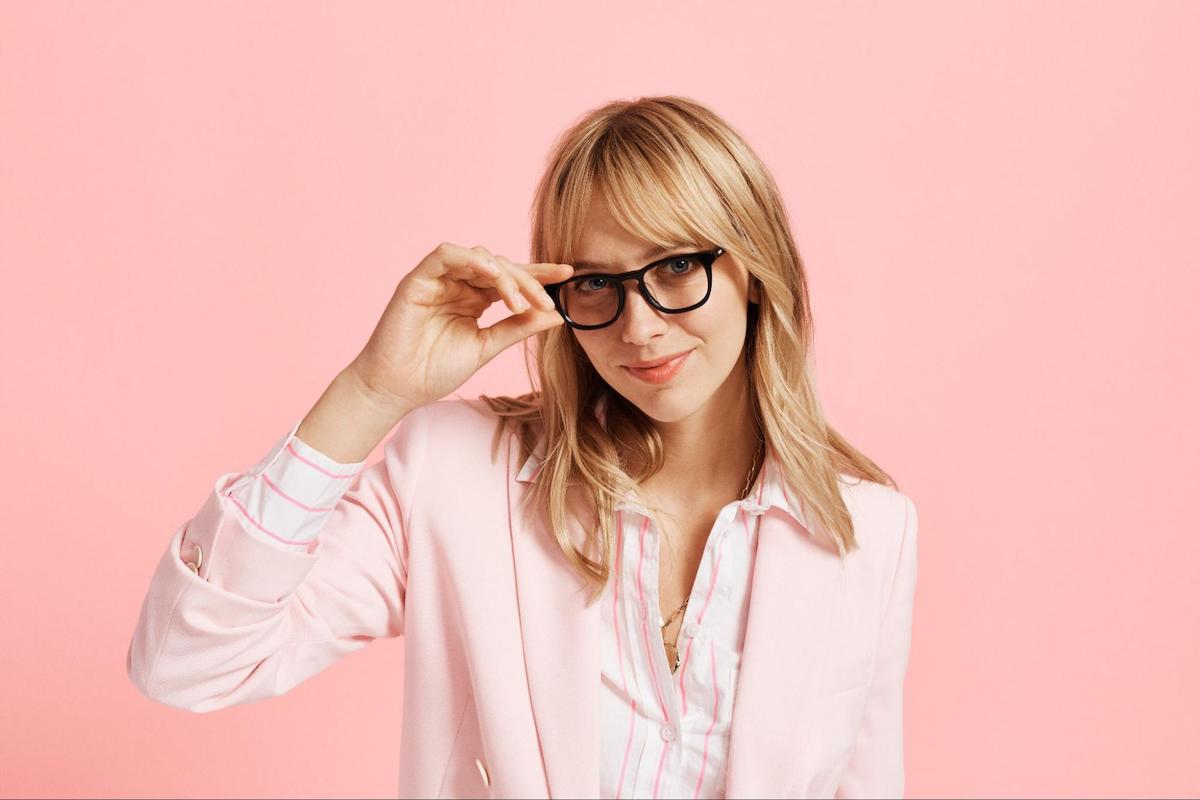 Eyeglasses storage: woman posing at the camera and holding her eyeglasses